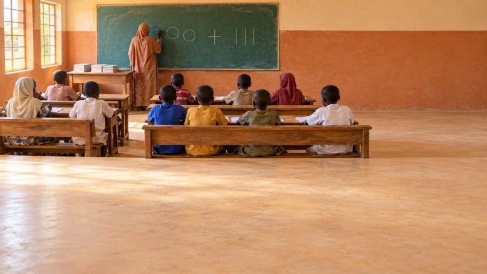 Nigeria basic education: primary classroom with new workbooks stacked on the teacher's table